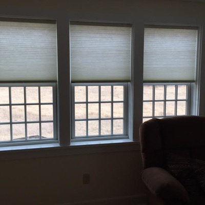 window shades over the top half of three windows