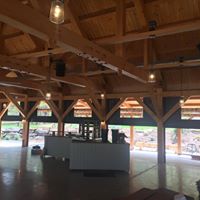 retractable screens on a post and beam outdoor venue