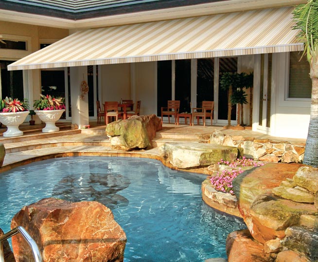 retractable awning over a swimming pool and patio