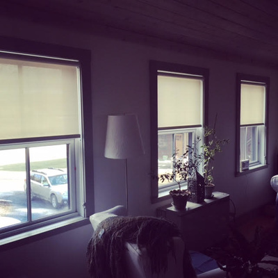 window shades over the top half of three windows